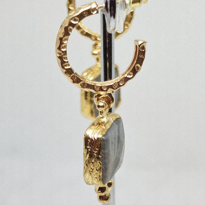 Pendientes de aro dorado con colgante cuadrado  de mineral gris. vista lateral